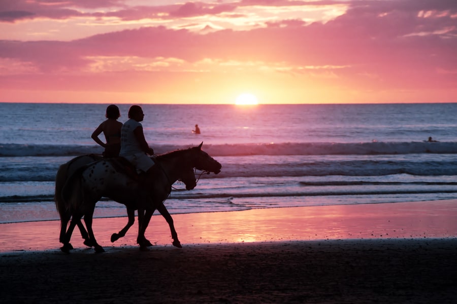 Horseback riding at sunset on the beach in Costa Rica by Tripps Plus